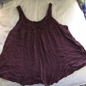 Flowy purple tank top with floral cut out designs.